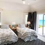 Oceanfront Haven: Elegant Estate With Private Deck