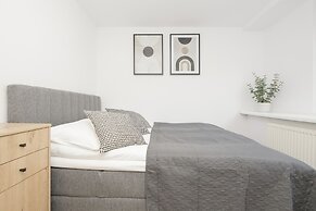 Grey Apartment Śródmieście by Renters