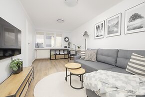 Grey Apartment Śródmieście by Renters