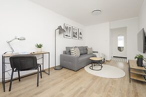 Grey Apartment Śródmieście by Renters