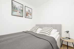 Grey Apartment Śródmieście by Renters