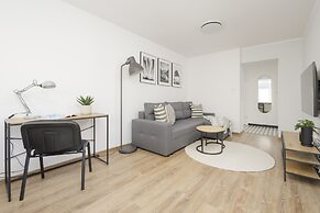 Grey Apartment Śródmieście by Renters