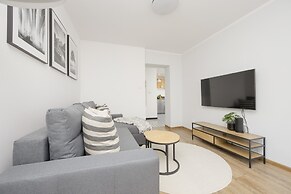 Grey Apartment Śródmieście by Renters