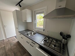 Chalet With Play Equipment, on a Holiday Park