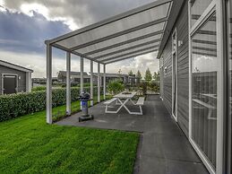 Modern Chalet on the Water at a Holiday Park