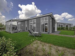 Modern Chalet on the Water at a Holiday Park