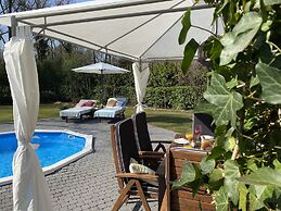 A Detached Bungalow With Outdoor Fireplace, Covered Terrace and Pond i