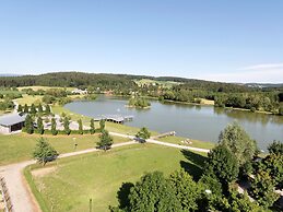 Wooden Chalet With Terrace Near a Swimming Lake