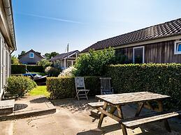 Bungalow With an Outdoor Fireplace by Water