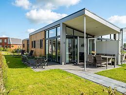 Bungalow With an Outdoor Fireplace by Water