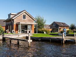 Bungalow With an Outdoor Fireplace by Water