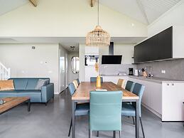 Bungalow With an Outdoor Fireplace by Water