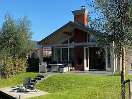 Bungalow With an Outdoor Fireplace by Water