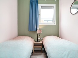 Bungalow With an Outdoor Fireplace by Water