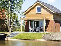 Bungalow With an Outdoor Fireplace by Water