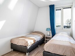 Bungalow With an Outdoor Fireplace by Water