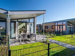 Bungalow With an Outdoor Fireplace by Water