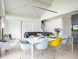 Bungalow With an Outdoor Fireplace by Water