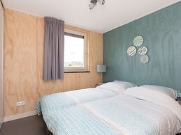 Bungalow With an Outdoor Fireplace by Water