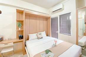 Warm and Well Designed Studio Room at Green Pramuka City Apartment