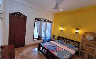 Malika's Yellow House