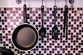 Homey 1BR with Spacious Living Room and Sofa Bed Green Pramuka Apartme