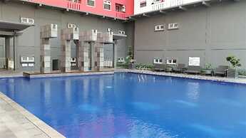 Homey 1BR with Spacious Living Room and Sofa Bed Green Pramuka Apartme