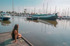 Chalet Gaby With Sauna, Private Dock, and Canoes at Lauwersmeer