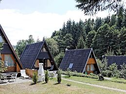 Wooden Chalet with Terrace near Swimming Lake