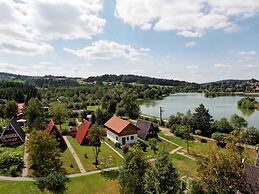 Wooden Chalet with Terrace near Swimming Lake