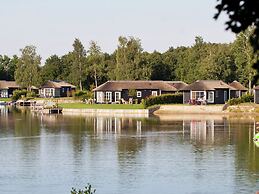 Thatched Lodge With a Combination Microwave, at a Holiday Park in Twen