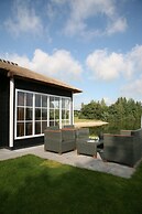 Thatched Lodge With a Combination Microwave, at a Holiday Park in Twen