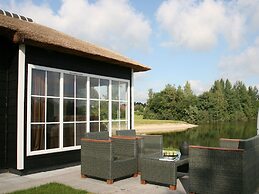 Thatched Lodge With a Combination Microwave, at a Holiday Park in Twen