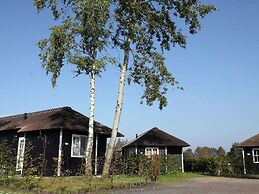 Thatched Lodge With a Combination Microwave, at a Holiday Park in Twen