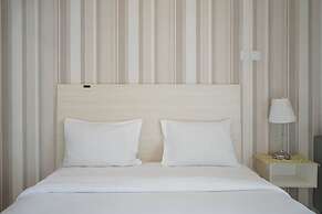 Minimalist and Stylish Studio Skylounge Tamansari Apartment By Traveli