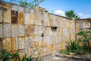 Saadani Safari Lodge - bush, river, beach