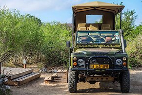 Saadani Safari Lodge - bush, river, beach