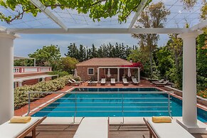 Dine on the Generous Veranda at a Rustic Stone Getaway