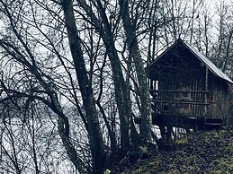 Tiny hut in the Forest Overlooking the River