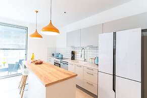 Sunlit Urban Escape with Balcony by Sea N Rent