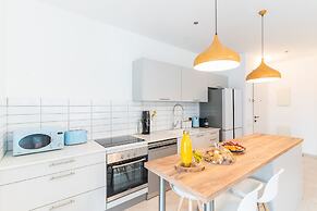 Sunlit Urban Escape with Balcony by Sea N Rent