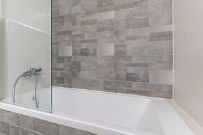 Sunlit Urban Escape with Balcony by Sea N Rent