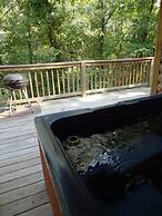 One bedroom, one bath log-sided cottage with private hot tub on Lake O