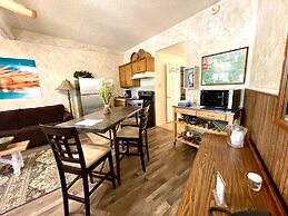 King Studio with king bed, dining area, sleeper sofa and view of Lake 