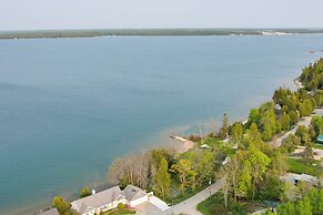 Lakefront De Tour Village Home w/ Deck & Fire Pit!