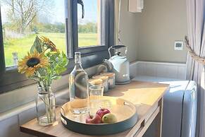 1br-sleeps2-field View-parking-cabin Experience