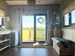 1br-sleeps2-field View-parking-cabin Experience