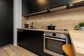 Studio Near Manufaktura Łódź by Renters